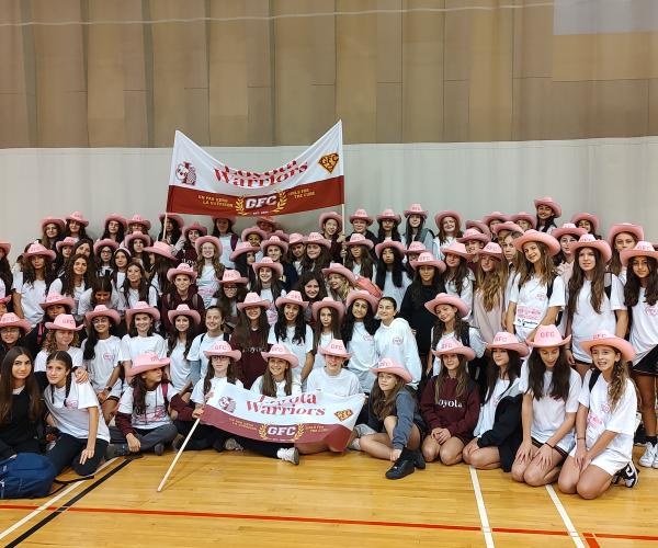 Loyola Girls posing with GFC Banner